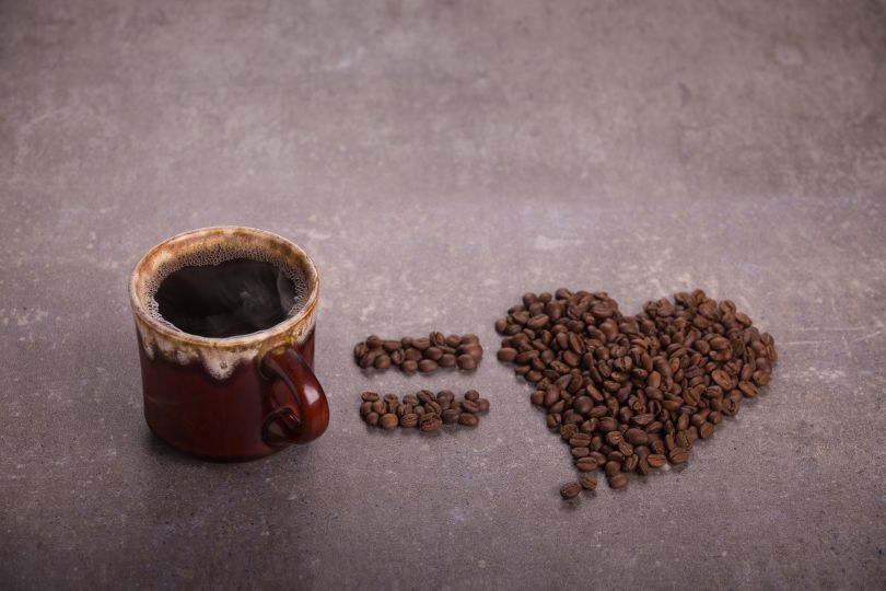 Coffee and heart made of coffee beans